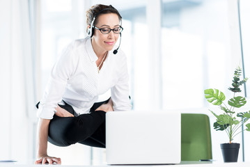 Smiling female looking at laptop