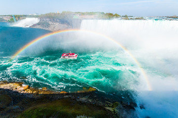Niagara Falls Hornblower Cruise Boat Approaching Waterfall Under a Perfectly Arched Rainbow