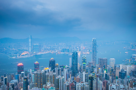 Hong Kong city skyline business district while storm is coming during blue hour in the evening.