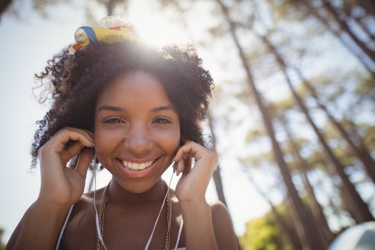 Portrait of smiling woman listening music