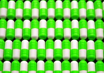 Medicine white and blue capsules pills background.