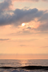 Naklejka na ściany i meble Glowing and Golden Summer Seashore Sunrise Over the Ocean
