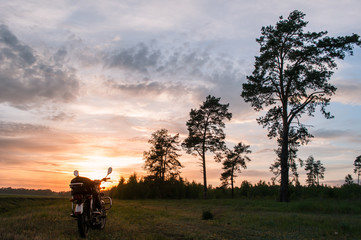 Naklejka na ściany i meble classic motorcycle on a sunset background,