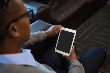 Male executive using digital tablet