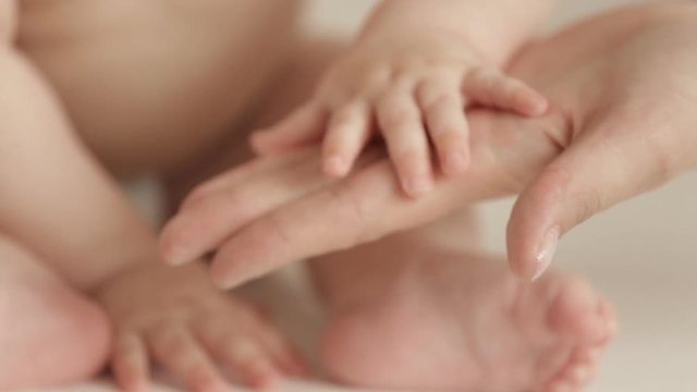 Newborn baby holding his mothers finger