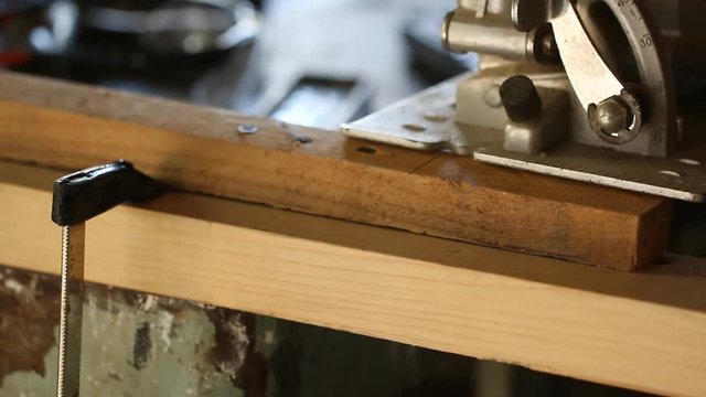 Circular saw cutting wooden plank