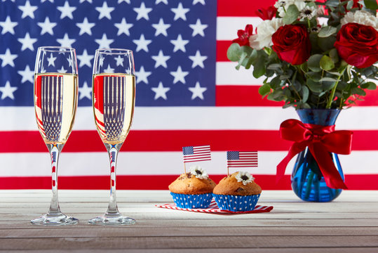 Beautiful bouquet, american flag and two glasses of champagne