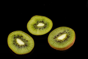 Kiwi fruits and slice kiwi fruits on black background