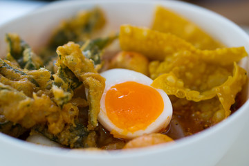 Yen-Ta-Four, Authentic Thai-style noodle soup with fishballs, crispy wonton skin, and special homemade red sauce.