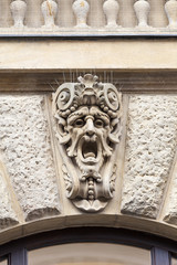Fototapeta na wymiar Relief on facade of old building, mascaron ornament, Prague, Czech Republic