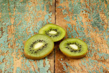 Kiwi fruits and slice kiwi fruits on blue wooden background