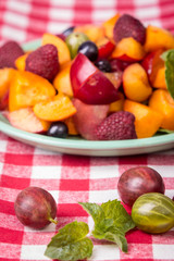 Fototapeta na wymiar salad with fresh fruits and berries