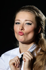 Obraz premium portrait of young beautiful caucasian female with pink lips and blue eyes kissing you or camera isolated on black background