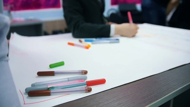 Students in the classroom draw with markers