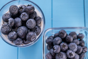 Freshly picked blueberries in milk yogurt with chia seeds