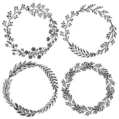 Set of hand drawn vector floral wreaths with leaves, flowers, berries.