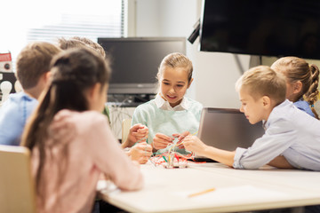 happy children with laptop at robotics school