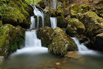 Spring landscape with huge water falling detail. Colossal cascade Tajovsky waterfall in Slovakia.