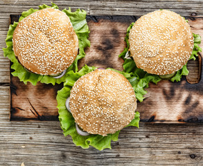 Hamburger on a wooden table. Rustic style, top view