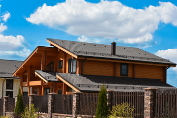 Part of the facade of a wooden house with windows