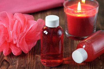 Obraz na płótnie Canvas Shower gel, shampoo, washcloth, towel, scented candle. Red
