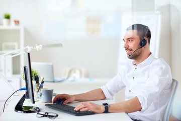 businessman with headset and computer at office