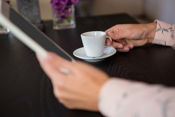 Hands of businesswoman holding coffee cup 