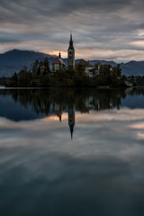 Fototapeta na wymiar Island Church and Reflection Early Morning- Lake Bled Slovenia