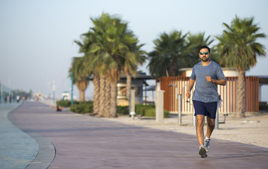 Fototapeta na wymiar man running on a running track near beach