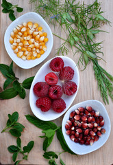 Cutting board with maize and raspberry dishes
