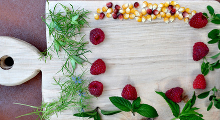 Cutting board with raspberries and mint on frame