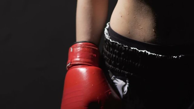 Sweaty woman in boxing gloves after fight, strong lady ready for self-defense