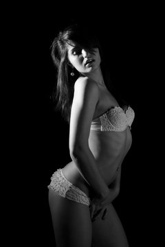 young beautiful female posing in white underwear. monochrome image