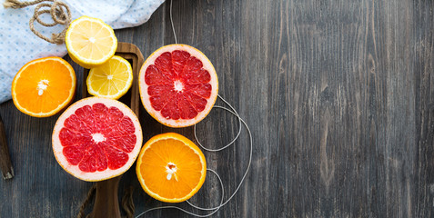 Citrus fruits on rustic wooden table. Copy space. Wide panoramic image.