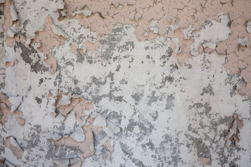 pink peeling paint on concrete wall texture 