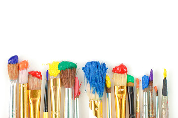 Row of artist paintbrushes closeup on artistic canvas. - obrazy, fototapety, plakaty