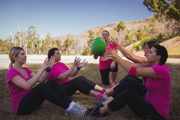 Female trainer instructing women while exercising 