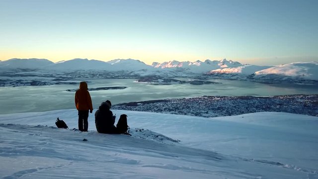 Two people sitting on a mountain