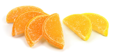 Orange and yellow marmalade in the form of lemon and orange candied slices isolated on white background.
