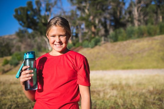 Girl holding a water bottle in the boot camp