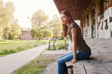 Fototapeta na wymiar Young girl sitting outdoors