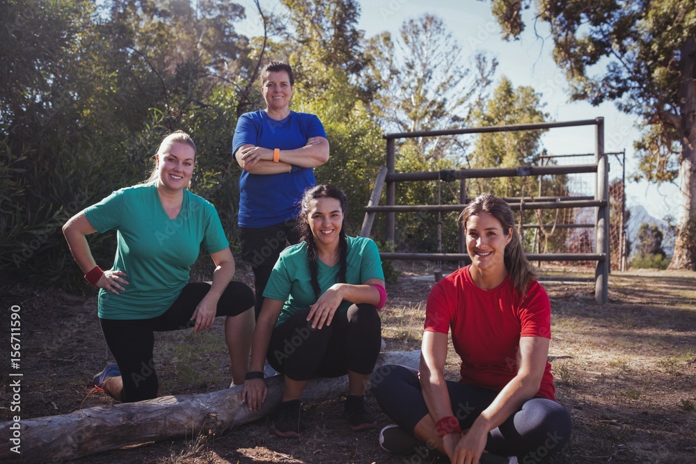 Wall mural Group of fit women relaxing together in the boot camp