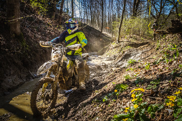 Motocross rider passes through the mud on the hardenduro race - obrazy, fototapety, plakaty