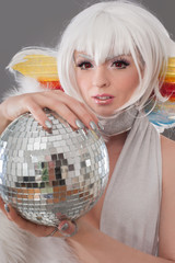 Glamour and sensual lady holding disco ball in luxury dress