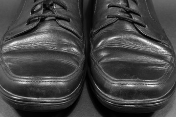 Old black man shoes. Front view