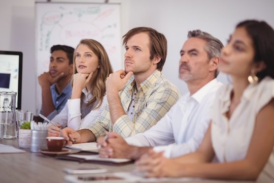 Business people sitting in conference room at office