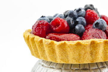 Berry Fruit Tart on metal stand with white background
