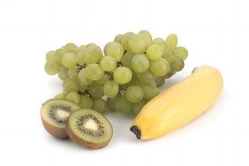 Green grapes, kiwi and bananas on a white background
