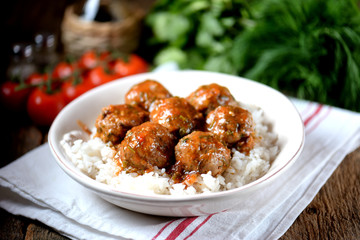 Beef meatballs with rice baked in tomato sauce.