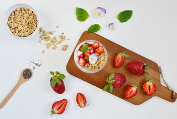 Yogurt with granola, honey, blueberries and strawberries, healthy breakfast